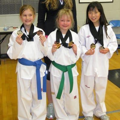 Three happy PST kids after a local Taekwondo Tournament