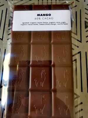 Made with 50/59 blend of cacao from Ecuador and Peru, this is 60% dark chocolate. Includes organic mango which gives it some spicy tones.