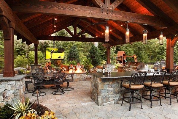 A covered patio and outdoor kitchen are perfect for hosting events.