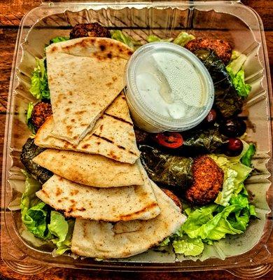 STUFFED GRAPE LEAVES AND FALAFEL COMBO: Served with tzatziki and Pita Bread. $13