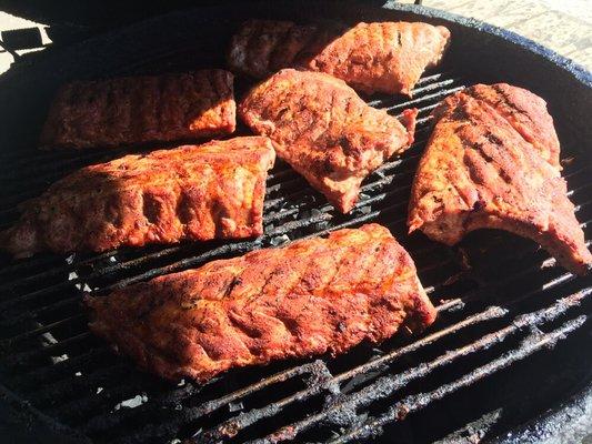 Baby back ribs smoking on one of our Big Green Eggs!