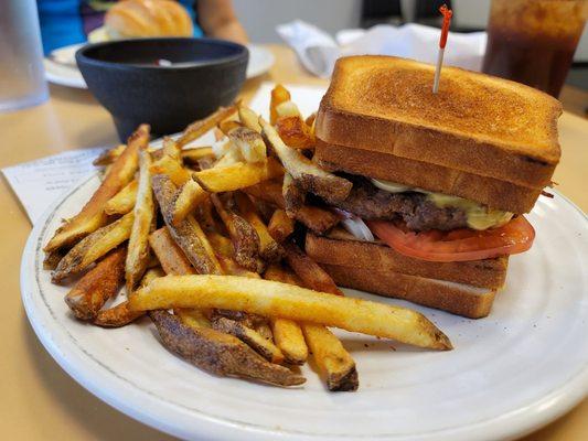 Melting Point! A crazy delicious burger nestled between to grilled cheeses severed with from-scratch fries.