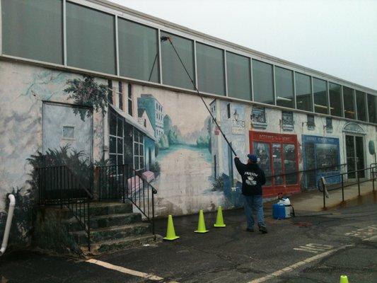 Professional window cleaning at a Suffolk County business above a beautiful mural