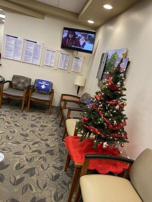 Part of festive waiting room, where every other chair is blocked from seating, adhering to social distancing guidelines