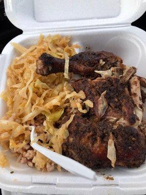 Jerk chicken plate side of cabbage and rice and peas