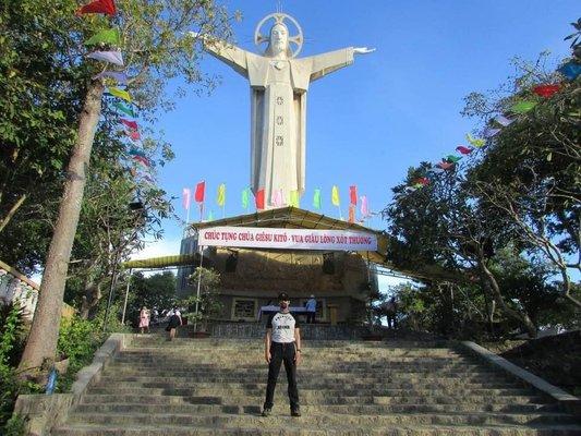 In Vung Tau, Vietnam I am standing under a huge statue of Christ that overlooks the town. There is a 50% devoted Catholic population here.