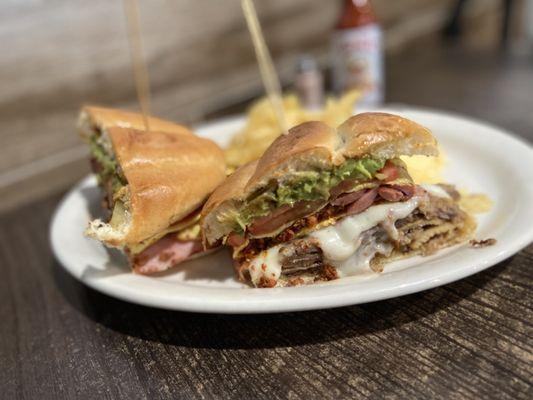 Del Rey Torta ($12) - Ham, mozzarella, pork sirloin, breaded beef, sausage-chorizo omelet, tomato, caramelized onions, avocado