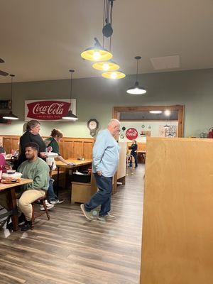 View from the booth. Large dining area through the doorway.