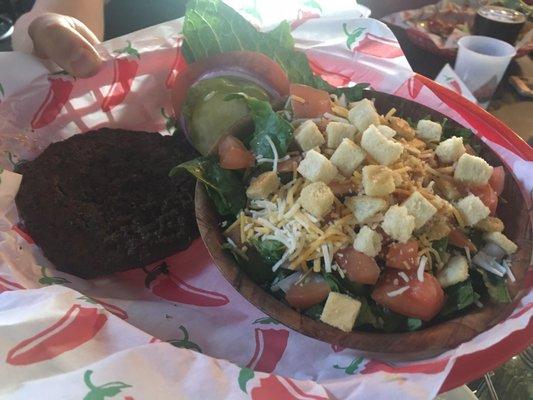 Salad with burger patty.