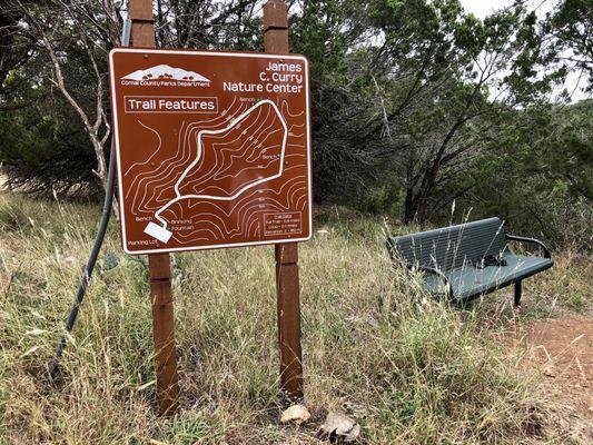 Trail map and bench at the trailhead