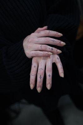 Ornamental dotwork finger and hand tattoos