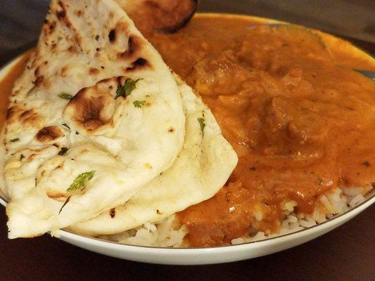 Butter lamb with rice and garlic nan bread.