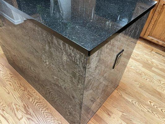 Island with new slab top and granite wrap found from a quarry that had been closed for 15 years.