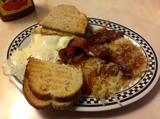 Two eggs over easy, hash browns, bacon and rye toast.