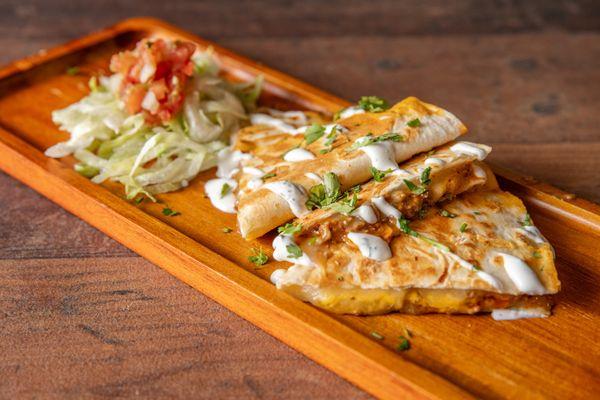 Quesadilla

A golden, crispy tortilla filled with melted cheese, served with fresh Pico de Gallo and your choice of crema.