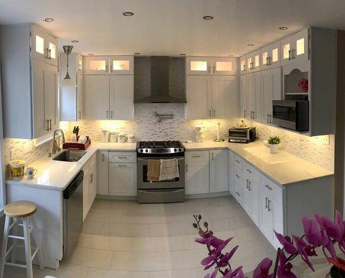 A project with white cabinet & countertops for a bright kitchen.