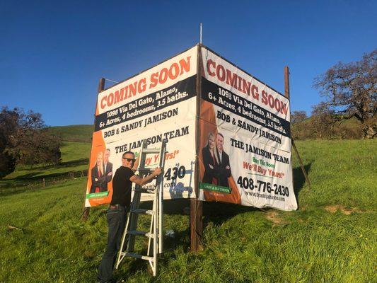 Realty companies | Bob putting up a billboard in Alamo, CA