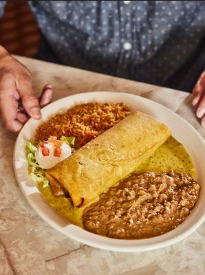 The Chuychanga! A flour tortilla fried and filled with chicken, cheese, cilantro and more. Served with sour cream and your choice of sauce.