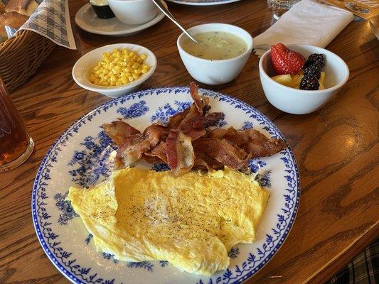 Bacon and eggs, corn, fruit, and turkey gravy to go with the biscuits