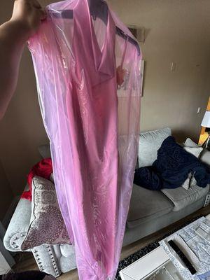 The dress still in the dry cleaning plastic