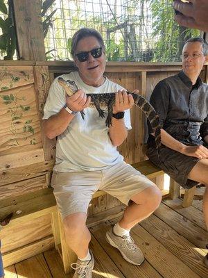 Hubby holding alligator. The guide slowly walked through crowd allowing each person to hold and get pictures!