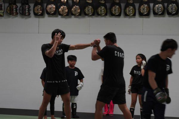 Coaches demonstrating in the 5pm MMA kids class. 
Monday, Wednesday, Friday