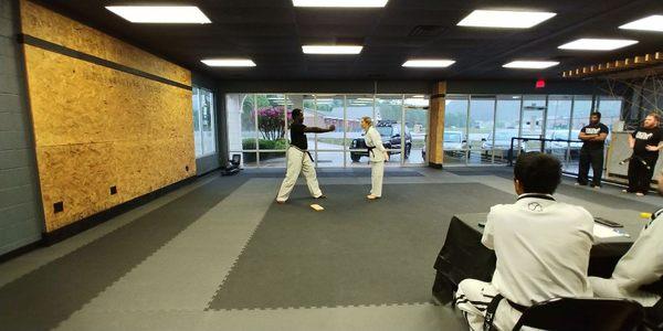 Board breaking at a black belt testing.