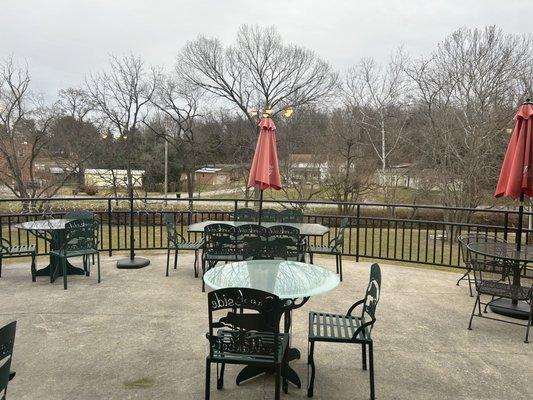 Outdoor seating overlooking creek.