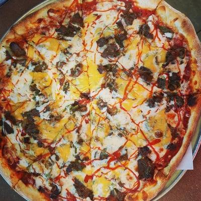 Philly cheese steak pizza. Tons of steak and bell peppers topped with cheese.