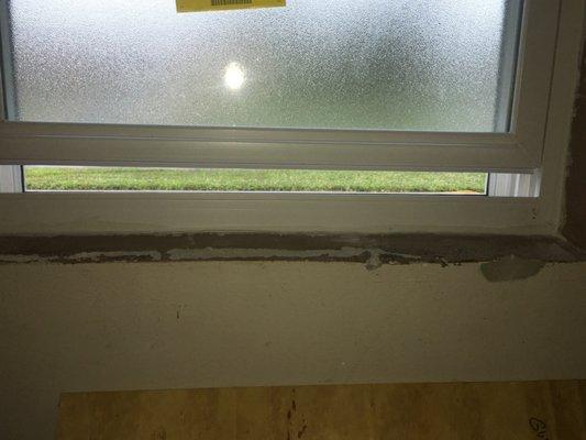 destroyed stucco window sill- repaired at own expense