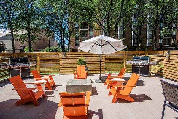 Outdoor community patios with grills and fire pits.