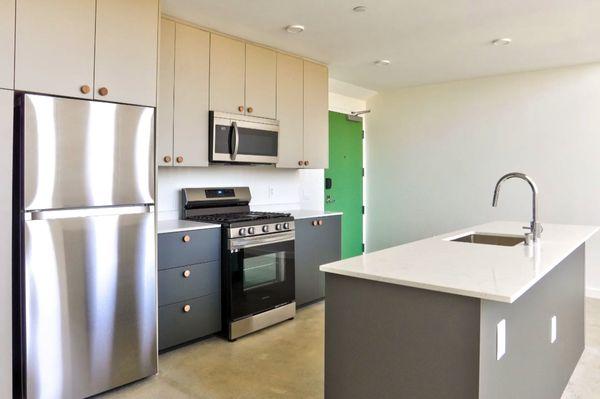 Kitchen Island with stainless steel appliances at The jagger Apartments in West Los Angeles.