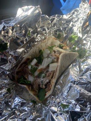 Pork taco with cilantro, onions and queso blanco.