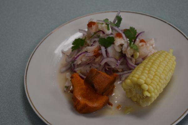 Ceviche de Pescado-- White Fish Marinated in Lemon & Lime juice, served with sliced sweet potato and corn