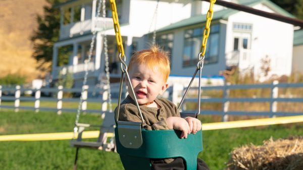 One of the little cuties enjoying the hot walker swing at the 3 Sisters Greenhouse + Pumpkin Patch.