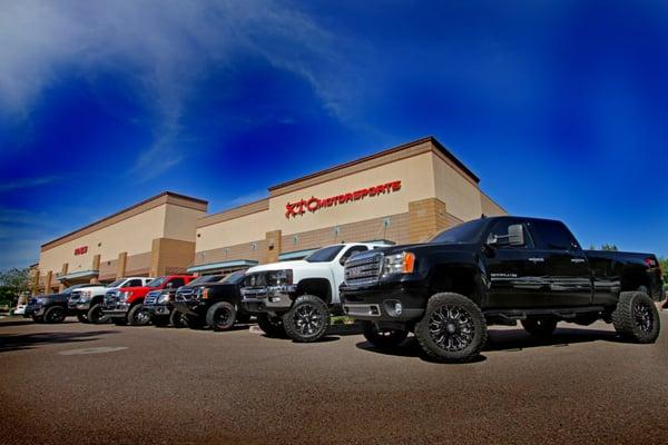 Groupl of customers vehicles in front of shop before heading to Races