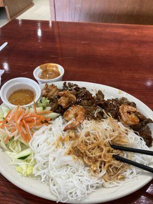 BBQ pork and shrimp with rice noodles and salad.