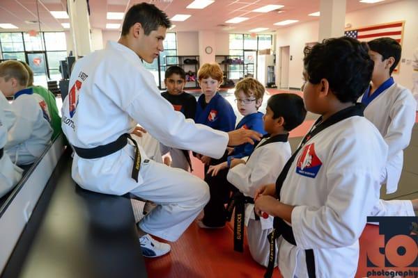 Mr Wegert mentoring some new black belts