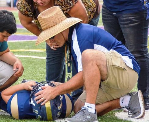 Dr. Clarizio, Team Doctor for the Glendale Bears assessing an injury.