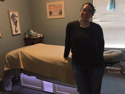 Jennifer in her massage room with her new stationary and super comfy massage table