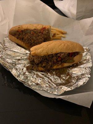 Steak and cheese sandwich with American cheese, onions, and peppers.