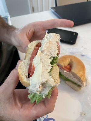 White Fish Salad with Cream Cheese, Tomato, and Onion on A Bagel Sandwich