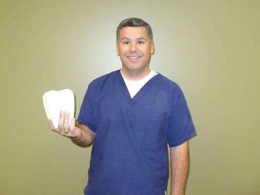 Silly Dr. Chesson holding a large tooth---SMILE!