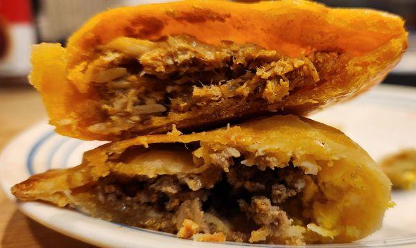 cross sections of chicken (top) and beef (below)  empanadas.