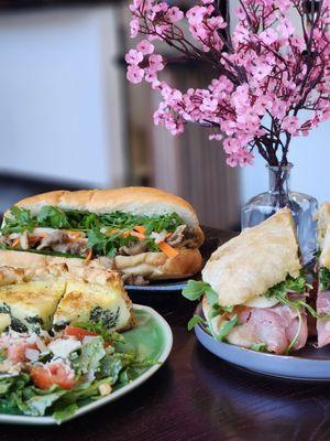 Florentine quiche + salad (front left), grilled pork banh mi (back), Tuscany italiano sandwich (right)