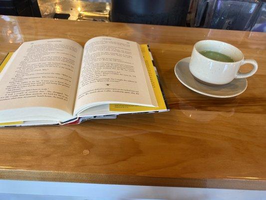 Reading my book drinking the matcha tea