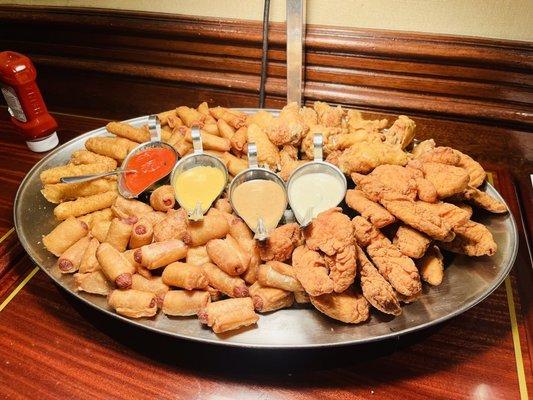 Amazing platter including spring rolls, chicken tenders, mozzarella sticks, chicken wings and pigs in a blanket. Delicious!