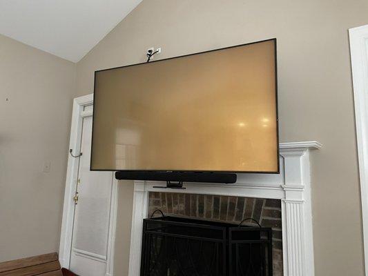 Mantel mount above brick fireplace In down, watching position