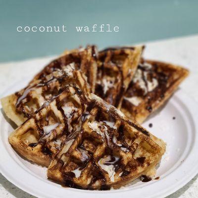 Coconut waffle with condense milk,  chocolate syrup and coconut flakes.