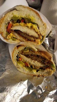 Grilled chicken breast sandwich with American cheese jalapeno peppers.